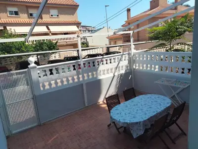 a balcony with a blue table and chairs on it at Apartamento Canet de Berenguer con terraza exterior a 100m de la playa in Canet de Berenguer