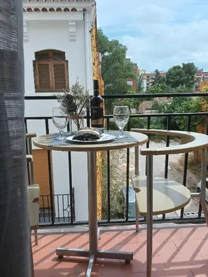 a table with wine glasses on a balcony at El Molino 2 Buñol Apartamento in Buñol