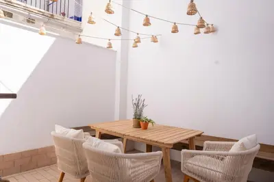 a dining room with a wooden table and chairs at Apartamento con patio playa cabanyal in Valencia