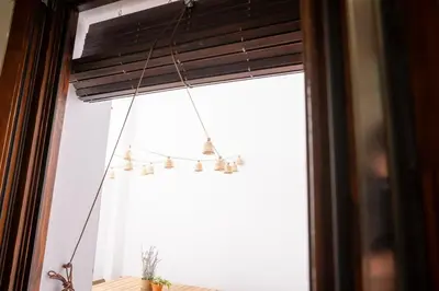 a chandelier hanging from a window in a room at Apartamento con patio playa cabanyal in Valencia