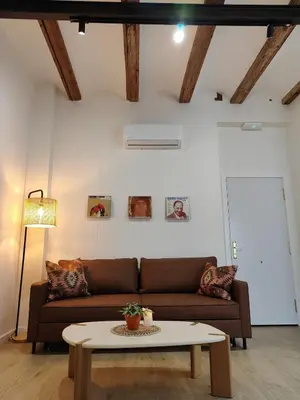 a living room with a couch and a table at Apartamento con patio playa cabanyal in Valencia