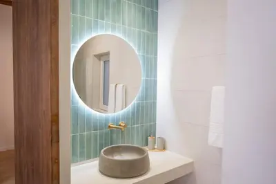 a bathroom with a round sink and a mirror at Apartamento con patio playa cabanyal in Valencia