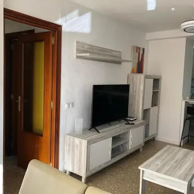 a living room with a flat screen tv on a entertainment center at Torres del Saler, Gola de Puchol, Valencia in Valencia