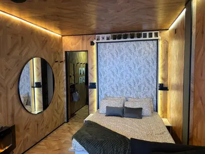 a bedroom with a bed and a mirror at Farnals Playa Valencia in Masalfasar