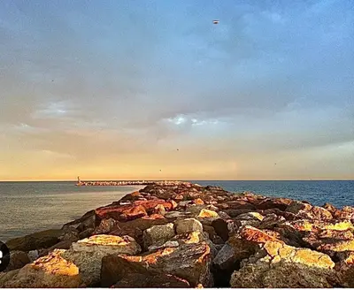 a group of rocks on the shore of the ocean at Farnals Playa Valencia in Masalfasar
