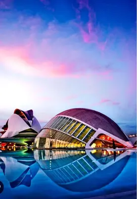 a view of a building in the water at night at Farnals Playa Valencia in Masalfasar