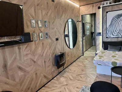 a bedroom with a wooden wall with a mirror and a bed at Farnals Playa Valencia in Masalfasar
