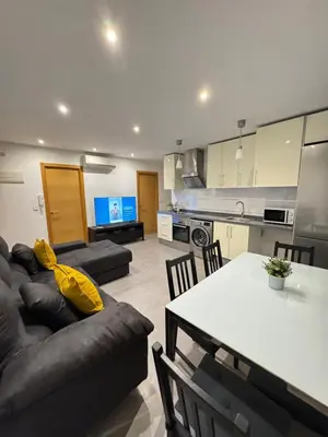 a living room with a couch and a table at UIM Mediterraneo Hispanidad 4 Wifi in Puerto de Sagunto