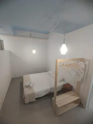 a small bedroom with a bed and a light at Confortable apartamento cerca de la playa in Valencia