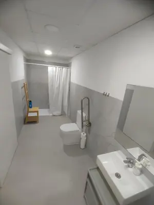 a bathroom with a toilet and a sink and a mirror at Confortable apartamento cerca de la playa in Valencia