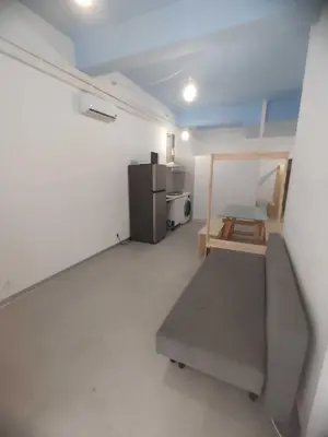a room with a refrigerator and a chair in it at Confortable apartamento cerca de la playa in Valencia