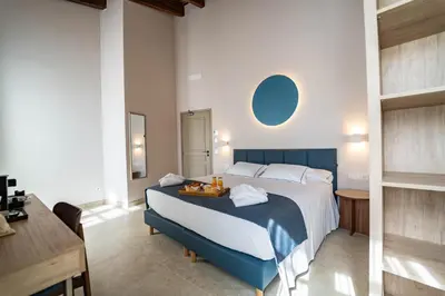a bedroom with a large bed with two towels on it at Hotel San Lorenzo Boutique Catedral in Valencia
