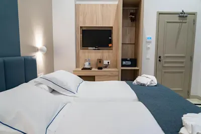 two beds in a room with a fireplace at Hotel San Lorenzo Boutique Catedral in Valencia