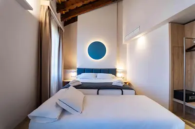 a bathroom with a sink and a bed at Hotel San Lorenzo Boutique Catedral in Valencia