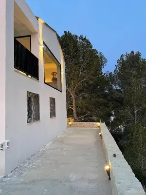 a white house with lights on the side of it at Casa with View in Alginet