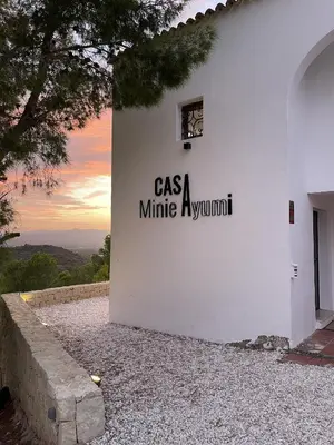a white building with a sign on the side of it at Casa with View in Alginet