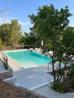 a swimming pool with a tree in front of it at Casa with View in Alginet