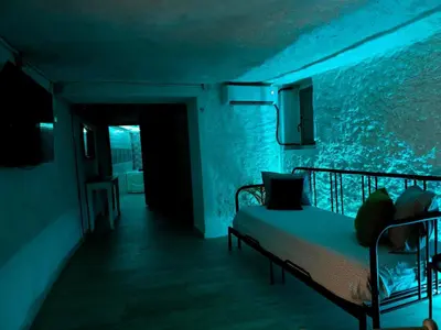 a bedroom with a bed in a room with an aquarium at Bonita casa cueva con jacuzzi in Paterna