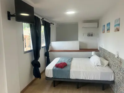 a small bedroom with a bed and a window at Casa Perenchiza in Chiva