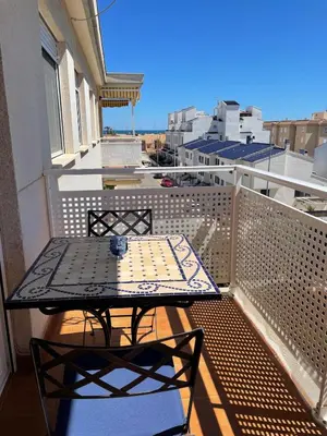 a patio table on a balcony with a view at Encantador Apartamento dúplex con vistas al mar in Canet de Berenguer