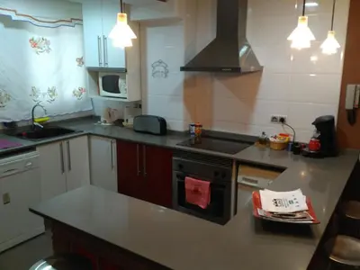 a kitchen with a sink and a stove top oven at Apartamento Cabañal in Cullera