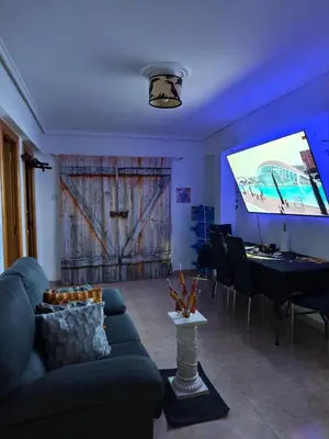 a living room with a couch and a projection screen at Habitación Manises Aeropuerto in Manises