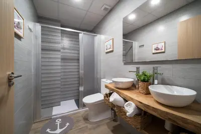 a bathroom with two sinks and a shower at Flats Piera Valencia Center in Valencia