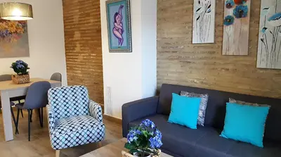a living room with a blue couch and a table at Flats Piera Valencia Center in Valencia