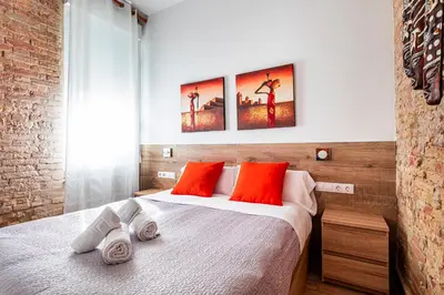 a bedroom with a bed with red pillows on it at Flats Piera Valencia Center in Valencia