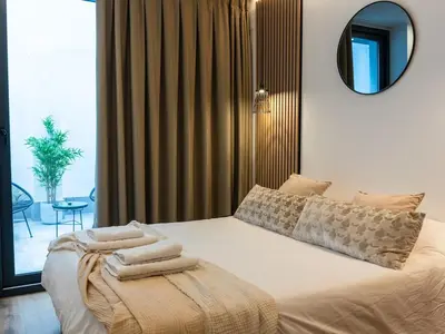 a bedroom with a bed with towels on it at Dos Corazones in Valencia