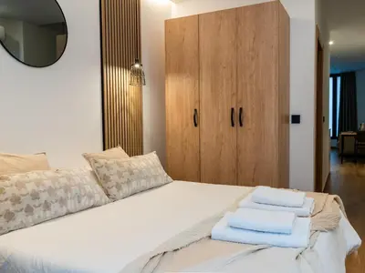 a bedroom with a white bed with towels on it at Dos Corazones in Valencia