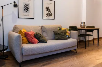 a couch with colorful pillows on it in a living room at Dos Corazones in Valencia