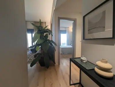a living room with a plant on a table at Port Suites Corporate Living Apartments in Valencia