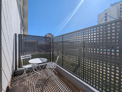 a balcony with a table and chairs on a building at Port Suites Corporate Living Apartments in Valencia