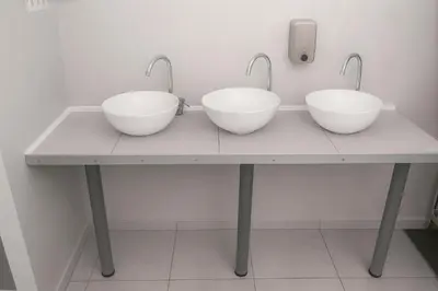 three bowls on a table with two faucets at Cozy Nook in Valencia