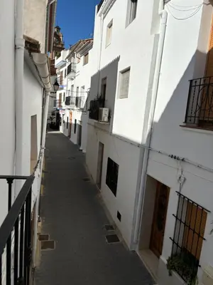 an alley in a city with white buildings at Casa Casidro in Chulilla