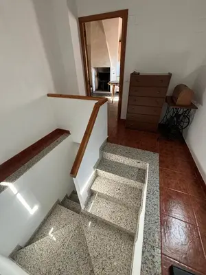 an empty room with stairs and a dresser at Casa Casidro in Chulilla