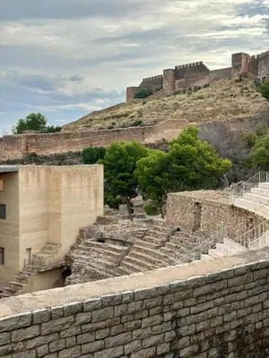 a stone amphitheater with a castle on a hill at Apartamento acogedor en el centro histórico de Sagunto in Sagunto