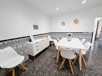 a dining room with white tables and white chairs at La Maison du Port in Puerto de Sagunto