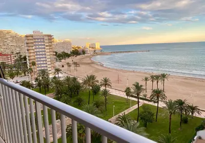 a balcony with a view of the beach and the ocean at Beach Apartment in Cullera