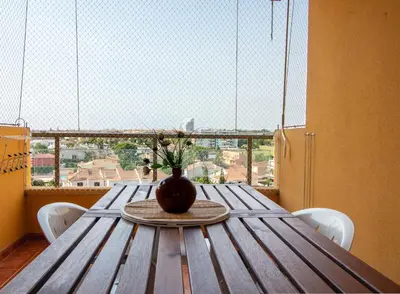 a wooden table with a vase on top of it at Global Vacacional, apartamento de una habitación en urbanización con piscina in Canet de Berenguer