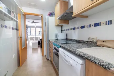 a kitchen with a sink and a counter top at Global Vacacional, Bonito apartamento cerca de la playa in Puerto de Sagunto