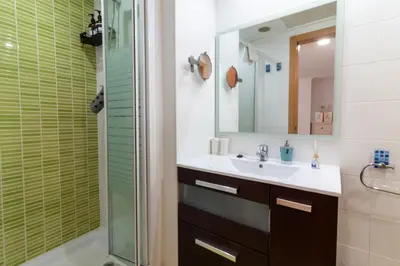 a bathroom with a sink and a shower at Global Vacacional, Bonito apartamento cerca de la playa in Puerto de Sagunto