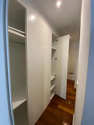 a walk in closet with white walls and wooden floors at Apartamento dúplex en el corazón de Valencia in Valencia