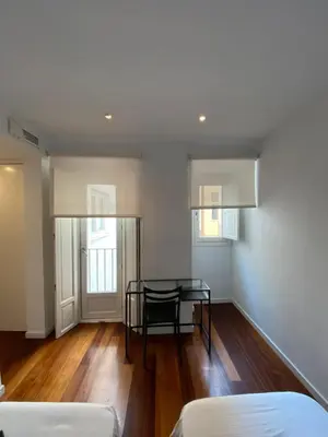 a living room with a table and a couch at Apartamento dúplex en el corazón de Valencia in Valencia