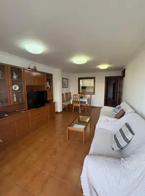a living room with a couch and a table at Apartamento Oasis in Cullera