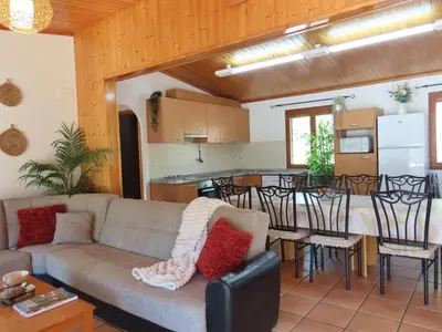 a living room and kitchen with a couch and a table at Casa Playamonte in Navarrés