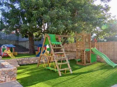 a playground with a ladder and a slide at Casa Playamonte in Navarrés