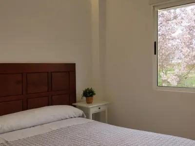 a bedroom with a bed and a window at Casa del Prado in Navarrés