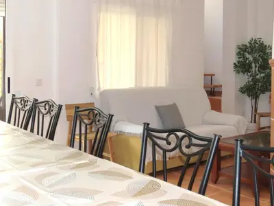 a dining room with a table and chairs and a table at Casa del Prado in Navarrés